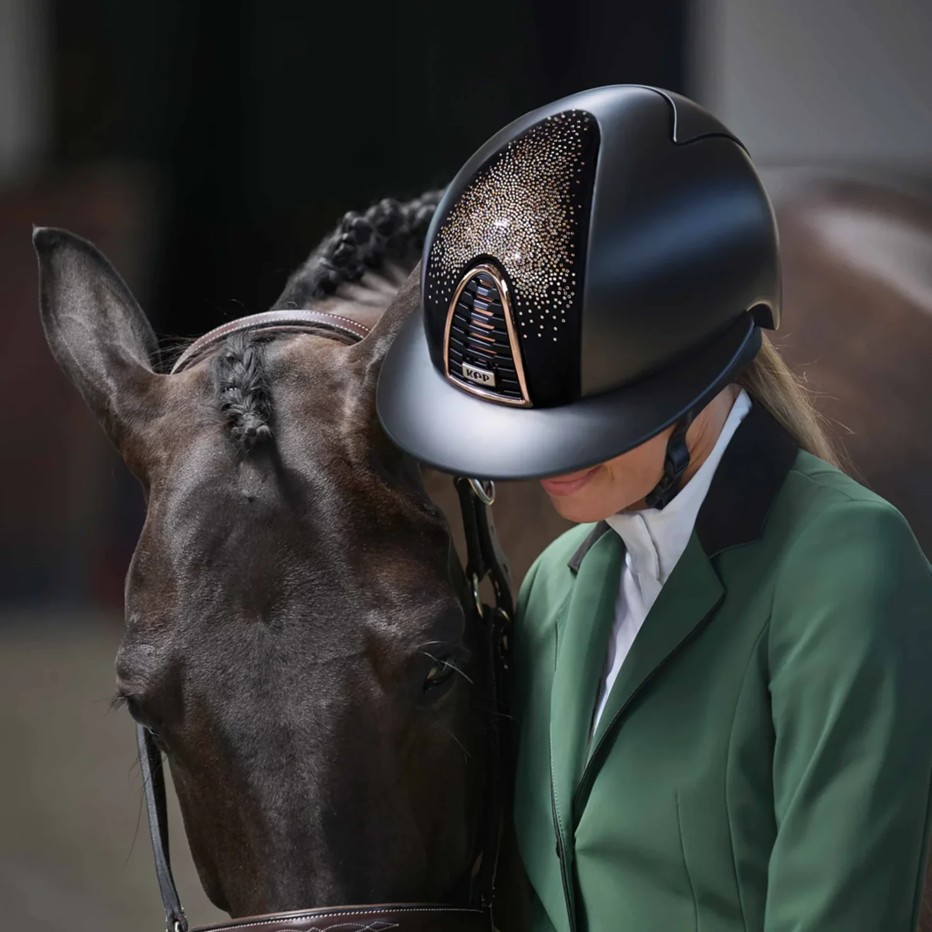 Rider wearing a crystal-detail KEP riding hat beside her horse